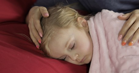 Fototapeta na wymiar Cute baby sleeping on the bed at home. Little girl sleeping in morning light