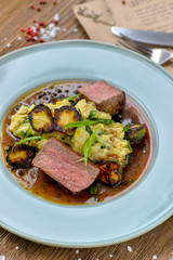 meat with vegetables and sauce in a beautiful serve