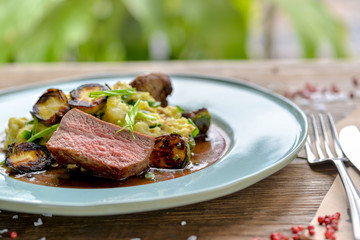 meat with vegetables and sauce in a beautiful serve