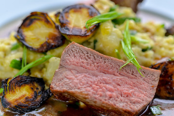 meat with vegetables and sauce in a beautiful serve