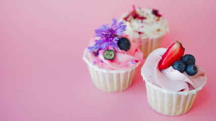 set of delicious cupcakes with different fillings and cream. Three muffin's with cream