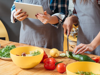 Online cookery course. Vegetarian diet recipe. Cropped shot of mother and daughter making salad with organic vegetables.