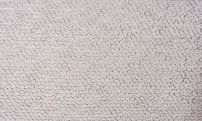 Surface patterned fabric shades of cream.