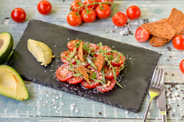 tomato salad with green sauce and herbs