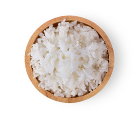 Rice in a wood bowl on a white background. top view