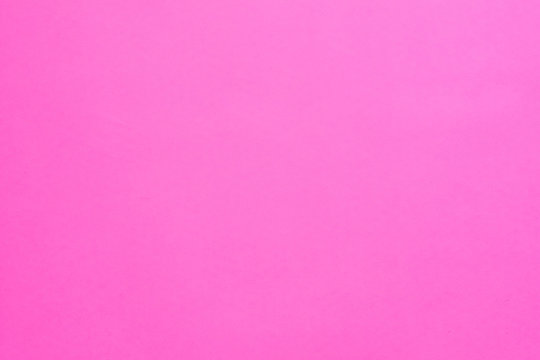 Vibrant pink solid color background. Plain magenta surface. Modern painting. Creativity and art. Bright wallpaper. Copy space.