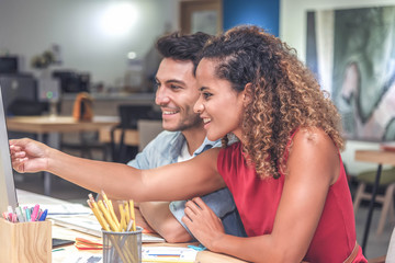 Young businessman and businesswoman in casual clothes having a new project discussion or having an idea at workplace.