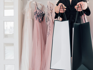 Evening gown showroom. Successful shopping. Cropped shot of female fashion consultant giving...