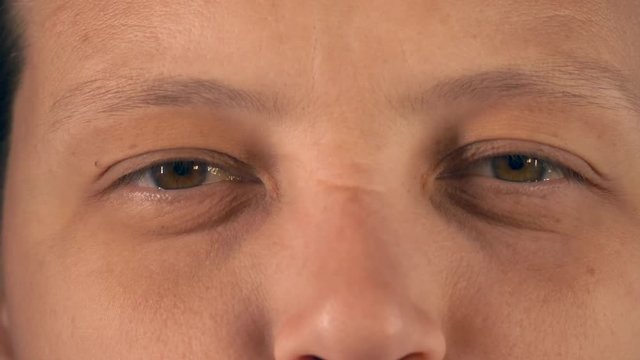 Young woman with tired eyes from long work at computer shows various exercises for eyes, approved by doctor. Gymnastics against strabismus. Remedial exercises. Ophthalmological allowance