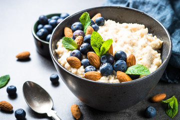 Oatmeal porridge with fresh berries and nuts. 