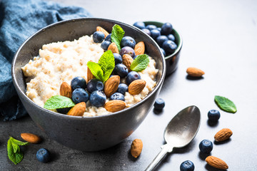 Oatmeal porridge with fresh berries and nuts. 
