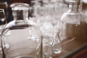 glass bottles, blurry background, many bottles
