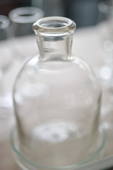 glass bottles, blurry background, many bottles