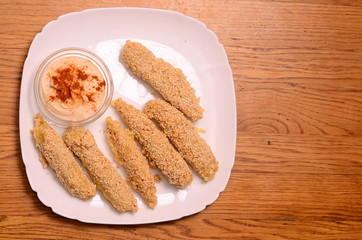 Pile of breaded crab sticks isolated
