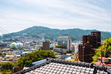 A sunny day in Nagasaki, Japan, with a view over the entire center, including the hills.