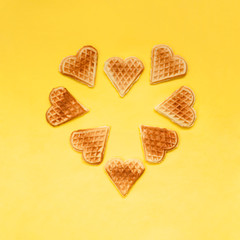 Crisp biscuit cookies waffles in shape of heart on yellow background. For holidays Valentine's Day, Women's Day, Mother's Day. Homemade sweets. love food concept