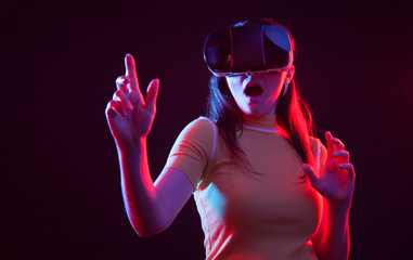 Young girl with VR goggles on head.