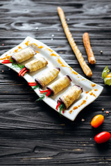 Eggplant rolls with cheese, red pepper and dill. snack at the banquet. Top view