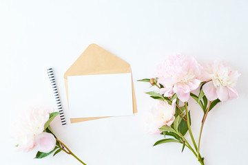 Mockup wedding invitation and envelope with light pink peonies on a white background