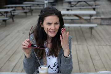 Fototapeta premium young woman in a park with coffee
