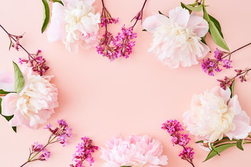 Flat lay composition with pink peonies on a pink background