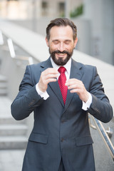 Waist up of joyful businessman gesticulating with his eyes closed