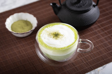 green tea latte in glass mug