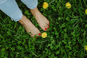 feet and hands of a woman with red manicure and pedicure