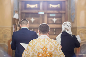 baby preparing for a baptismal ceremony, The sacrament of baptism. Attributes of an Orthodox priest...
