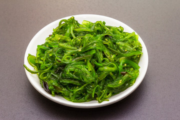 Traditional Japanese Hiyashi Wakame Chuka seaweed salad with sesame seeds.