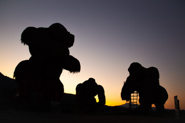 Silhouette three giant hay kingkongs  with sunset background in summer