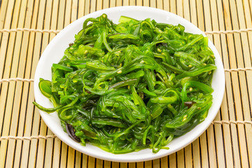 Traditional Japanese Hiyashi Wakame Chuka seaweed salad with sesame seeds.