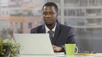 Businessman using a laptop in an office