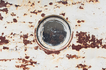 rusty submarine armoured porthole or window metal background.