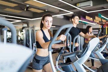 Fototapeta na wymiar Fitness Woman Doing A Cardio Session On Treadmill