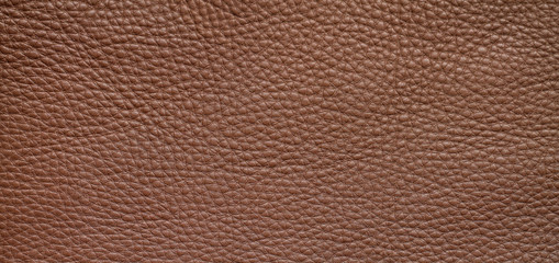 Natural background with brown leather of a rough texture.