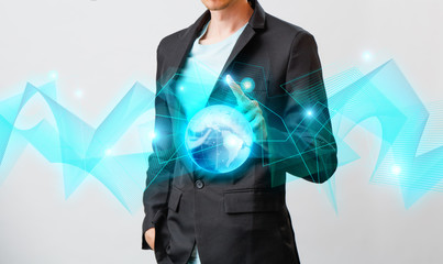 Businessman holding the glowing hologram digital globe. Concepr of business and innovation