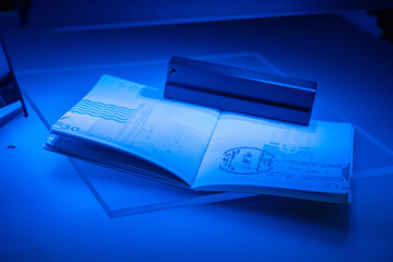 Checking the passport for fraud in UV and another light, detection of luminescence of protective components of the document (threads, melange fibers), special elements of high security print 
