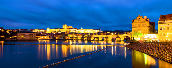 Charles Bridge over Vltava river in Prague, Czech Republic. Night with touristic boats