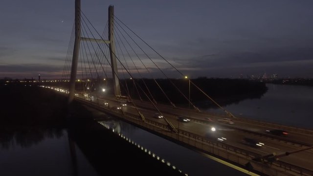 4K. Aerial view of the Siekierkowski bridge with the city of Warsaw Poland. night time