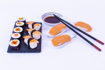 Sushi rolls, Salmon sushi roll, soy sauce, white rice, chopsticks and a white background