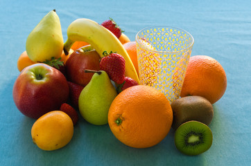 Colorful Fresh Fruits And Juice on blue sky background.