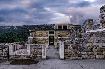 Knossos Palace, Crete / Greece. Archaeological site of Knossos in Heraklion at sunset. Cloudy sky