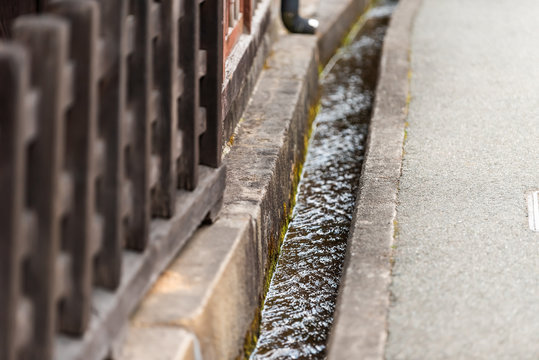 Takayama, Japan small canal gutters in Gifu prefecture closeup view of river in mountains in city