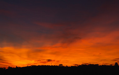 Wonderful colorful sunset sky and land silhouette