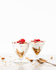 Fresh Raspberries on Top of Granola and Yogurt Parfait On Light Background, Space For Text
