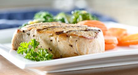 Grilled pork loin with broccoli covered in hollandaise sauce