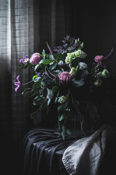 Amazing bouquet of flowers on a table into a dark vintage room