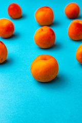 Symmetry of apricots with blue background.
