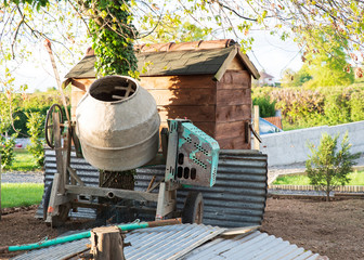 Concrete mixer in a garden in the countryside